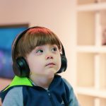 boy near white wooden shelf