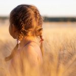 girl wearing pink camisole on brown plant during daytime