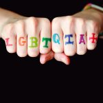 person with blue and red manicure