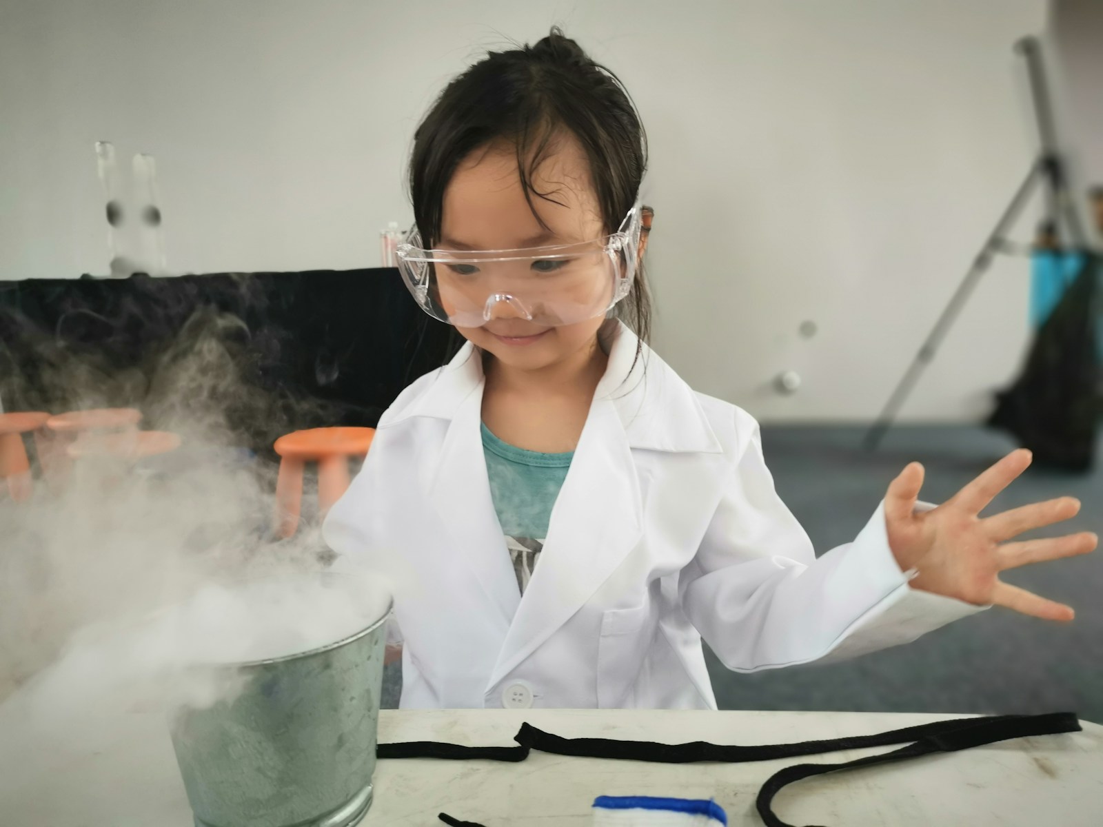 How to Spark Your Child's Love for Science and Nature Early 1 a little girl wearing a white lab coat and goggles