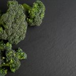 green broccoli on black textile