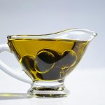 Photo of Olives on Cup of Olive Oil