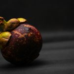 a close up of a fruit on a black background