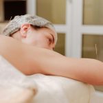 Woman With Acupuncture Needles Lying Down